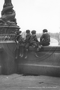 London Lads on Victoria Embankment by Blackfriars Bridge enjoying the Old Father Thames on a Saturday in London c1900s